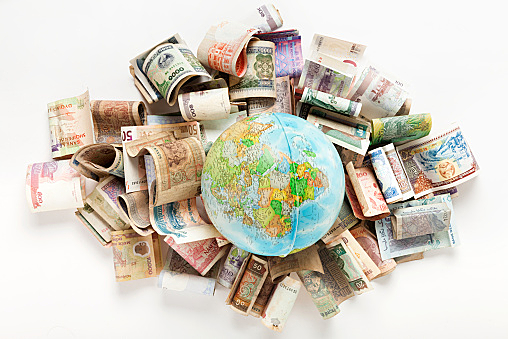 globe on Africa side laid on world banknotes